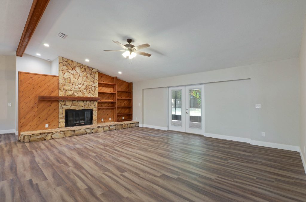 vacant real estate listing living room with stone and wood fireplace