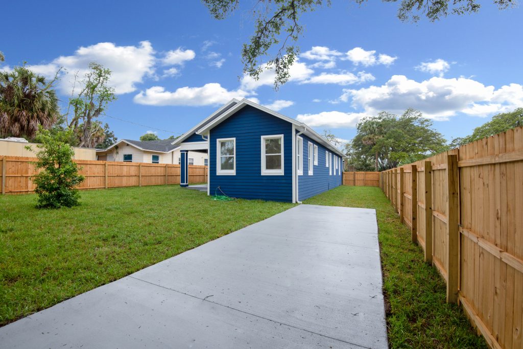 backyard photo of a blue bungalow home