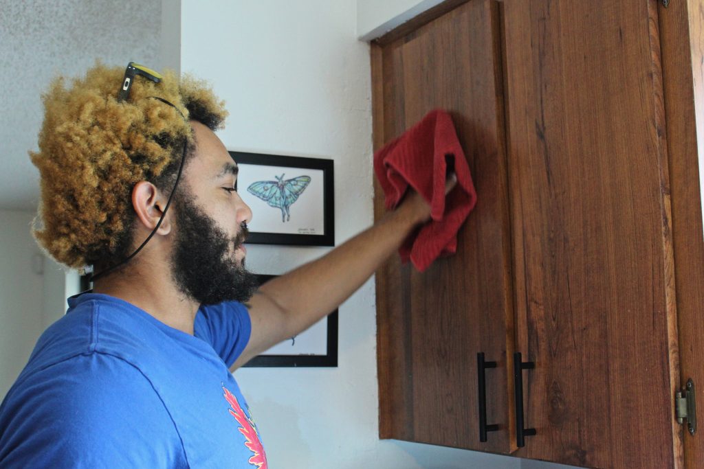 mutiracial man preparing his home for real estate listing photography