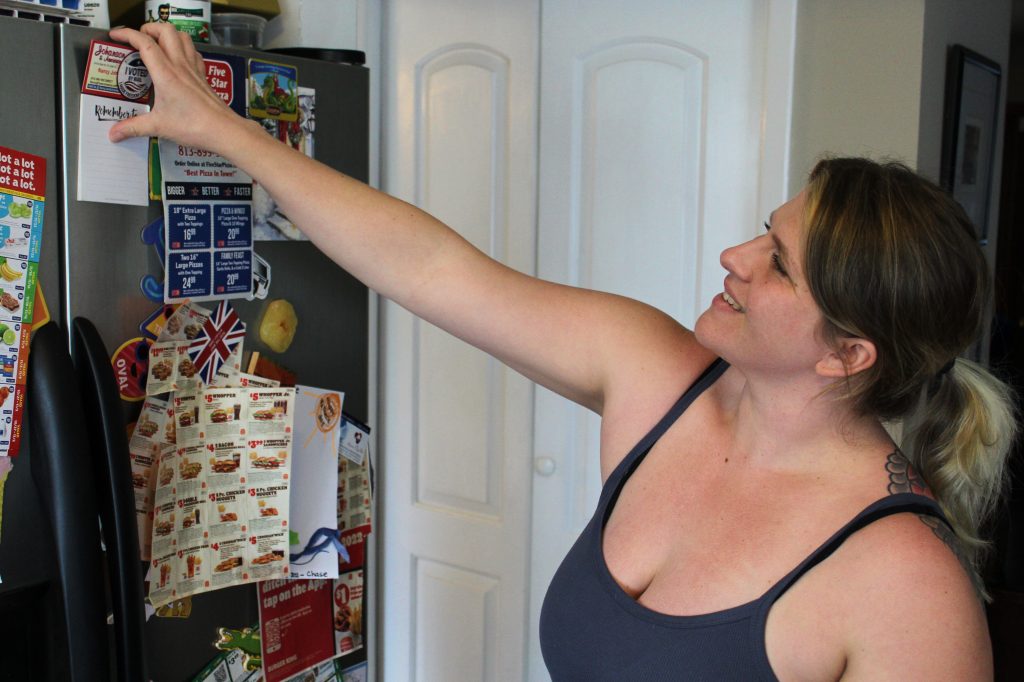 smiling white woman preparing her home for real estate listing photography