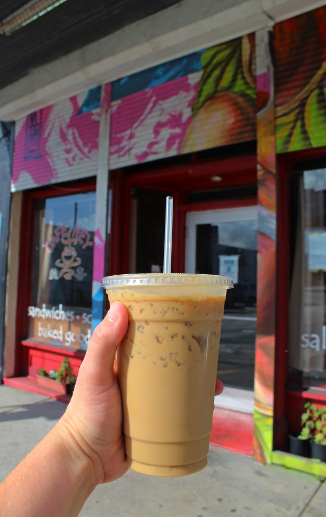 iced coffee drink photo with cafe in the background
