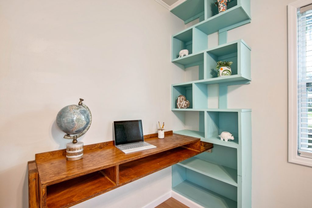 photo of a desk in a nook with built in shelving