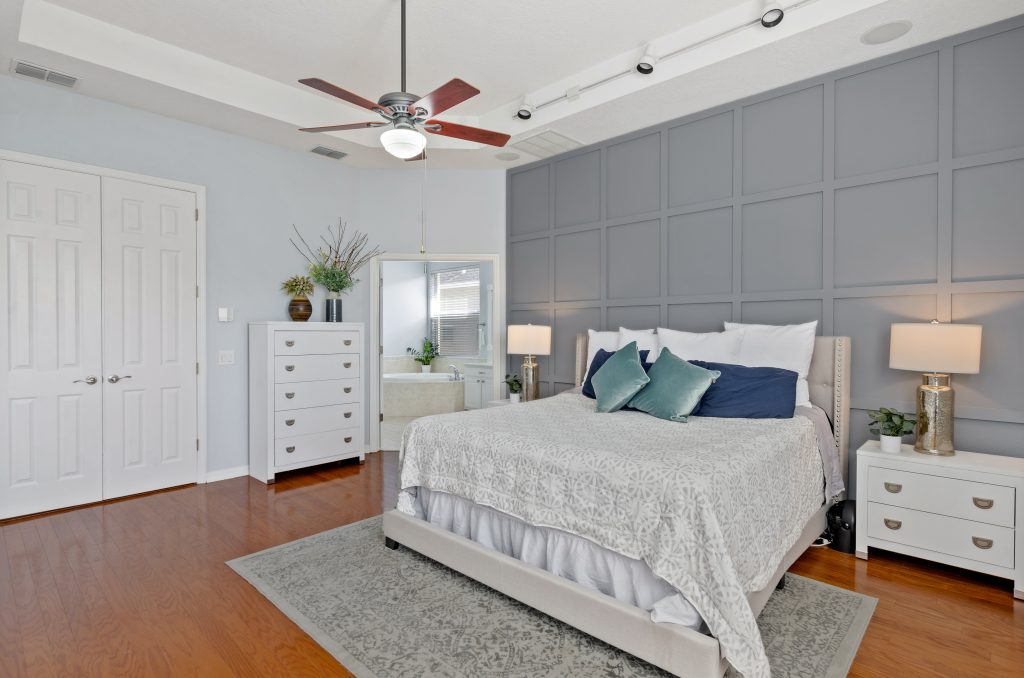 photo of a grey and white bedroom with accent wall