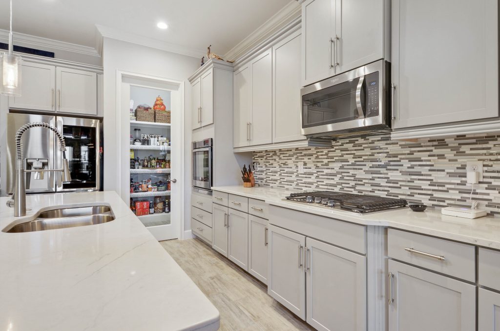 beautiful clean kitchen photo with pantry and smart refrigerator