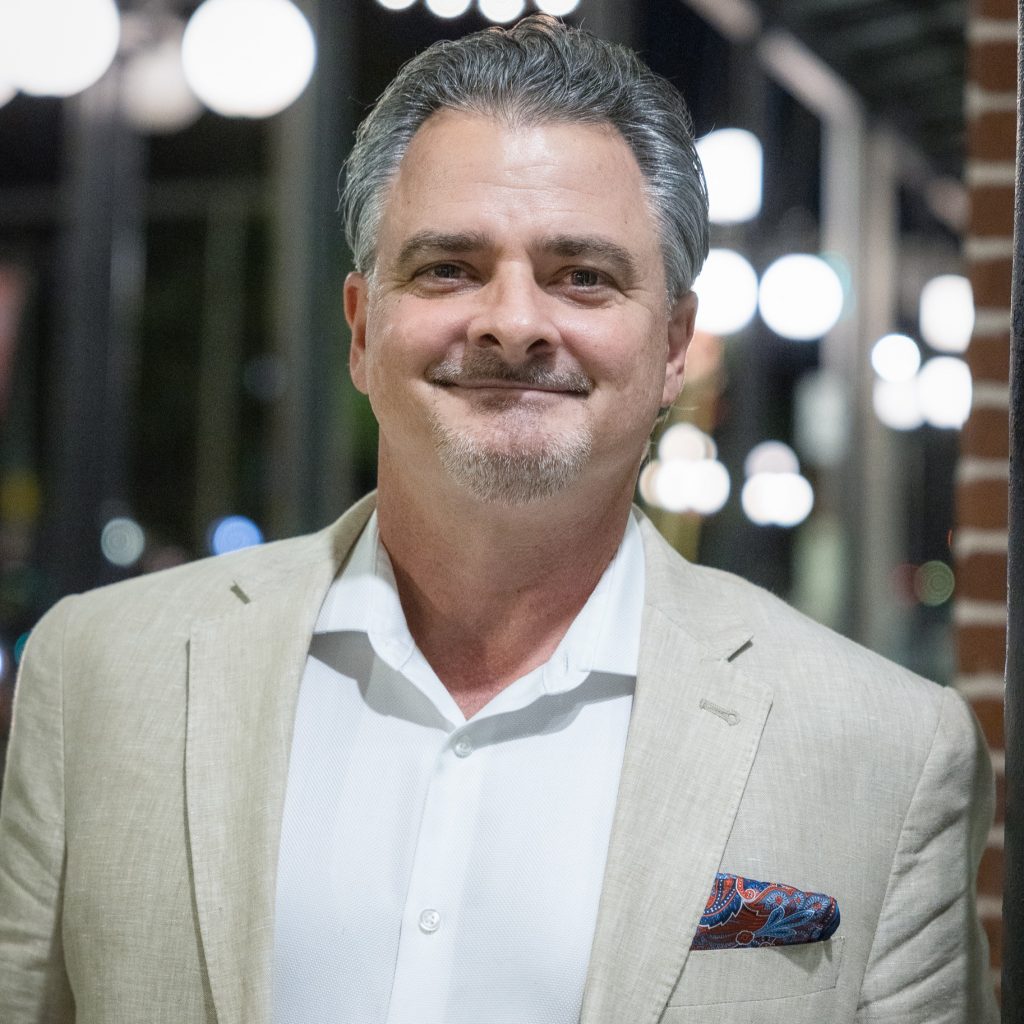smiling male real estate agent with salt and pepper hair