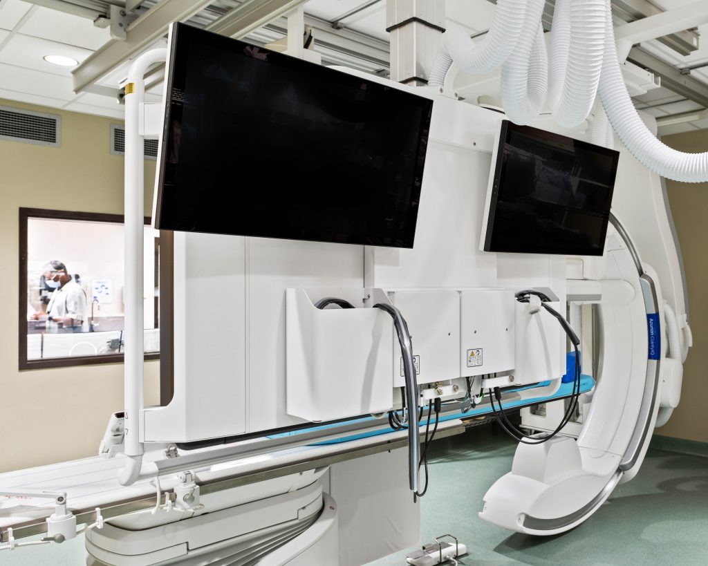 photo of monitors on a blue cord MRI machine in a hospital
